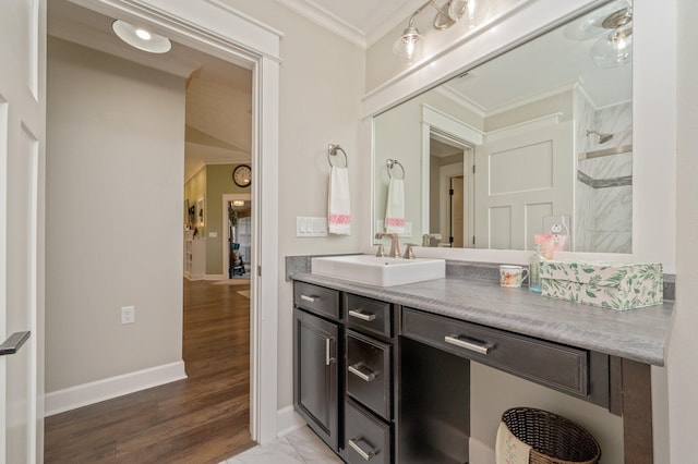 bathroom featuring hardwood / wood-style flooring, ornamental molding, vanity, and walk in shower