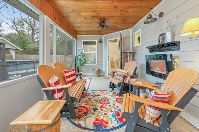 sunroom / solarium with wood ceiling and ceiling fan