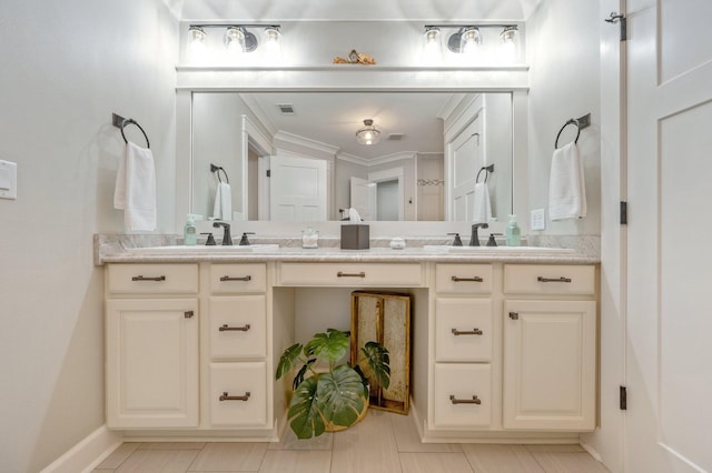 bathroom with crown molding and vanity