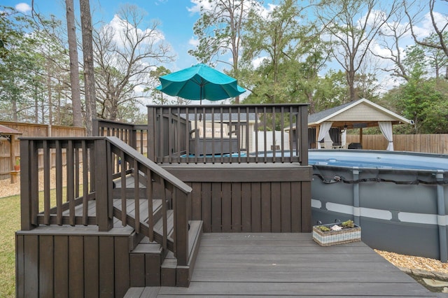 deck featuring a covered pool