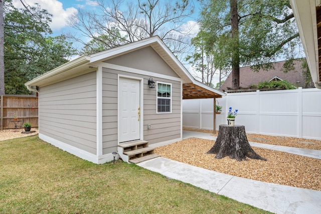 view of outbuilding featuring a yard