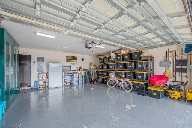 garage with a garage door opener, electric panel, and white fridge