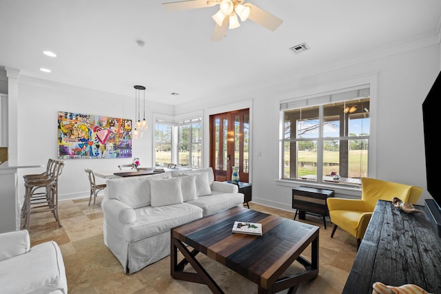 living area with baseboards, visible vents, and a healthy amount of sunlight