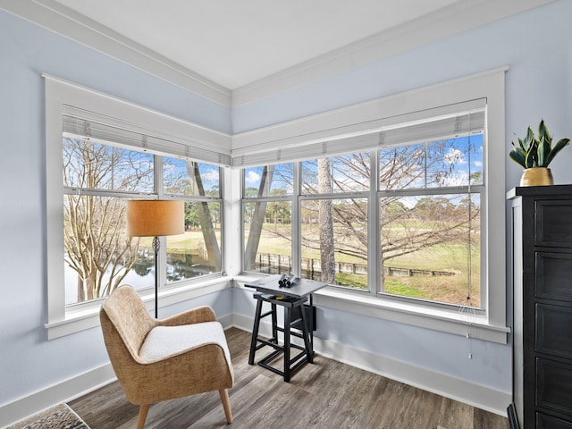 sunroom with a wealth of natural light and a water view