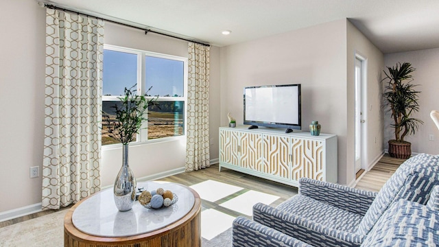 living room featuring baseboards and light wood finished floors