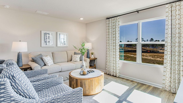 living area with light wood finished floors and baseboards