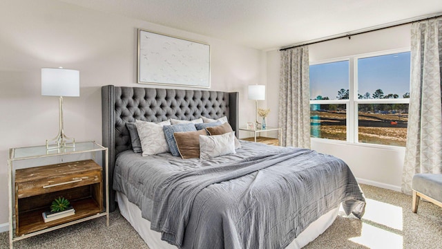 bedroom with carpet and baseboards