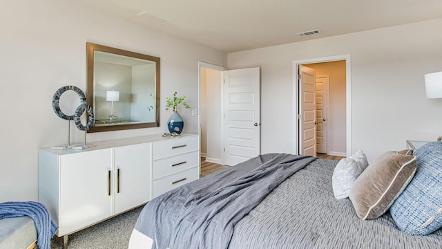 bedroom featuring baseboards and visible vents