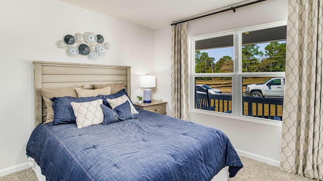 bedroom featuring light carpet and baseboards