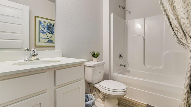 full bathroom featuring bathtub / shower combination, a textured wall, toilet, vanity, and wood finished floors