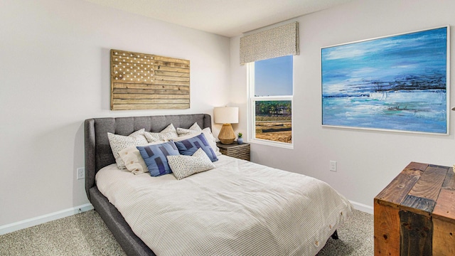 carpeted bedroom featuring baseboards