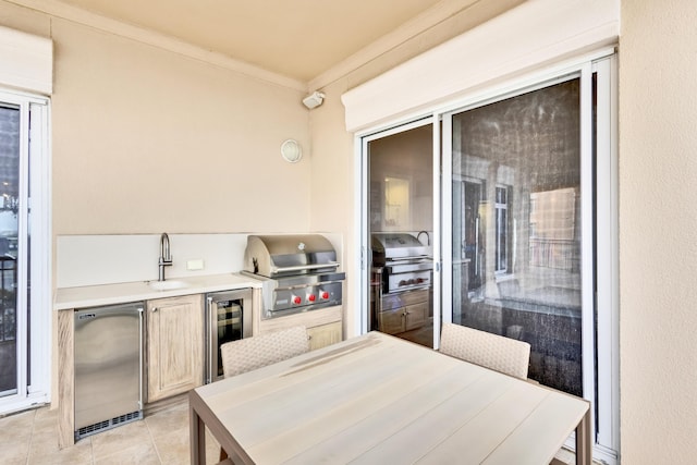 view of patio / terrace with area for grilling, sink, a grill, and beverage cooler