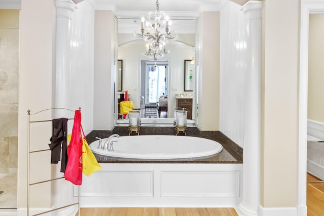 bathroom with hardwood / wood-style floors, a bath, and crown molding