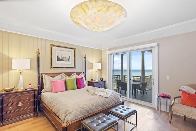 bedroom with a water view, crown molding, access to outside, and light wood-type flooring