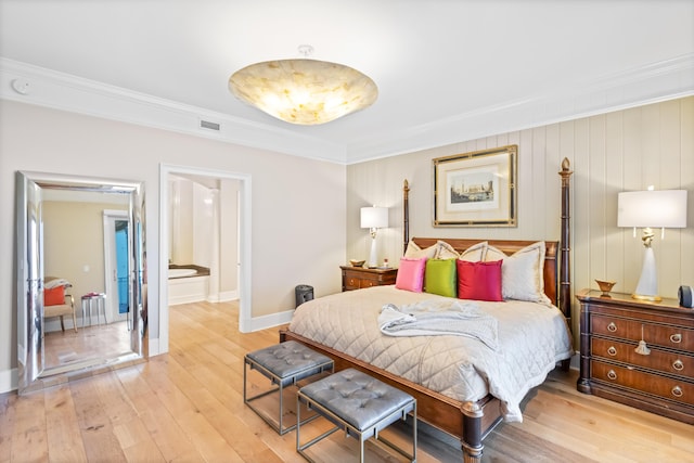 bedroom with ornamental molding and light hardwood / wood-style flooring