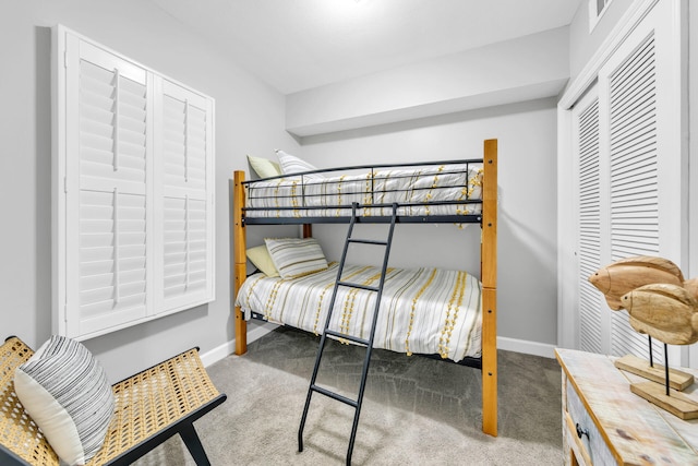 bedroom featuring light carpet, visible vents, baseboards, and a closet