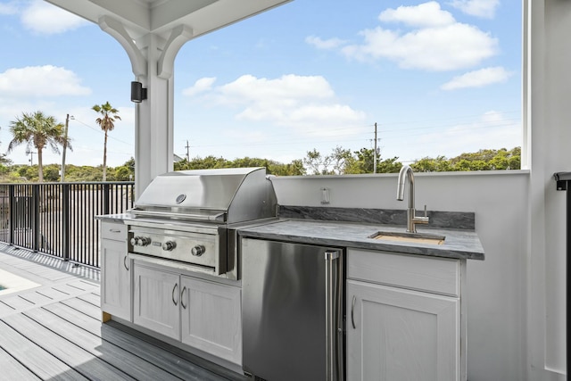 view of patio with area for grilling, exterior kitchen, and sink