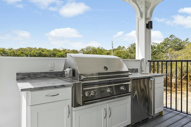 view of patio / terrace with an outdoor kitchen, sink, and area for grilling