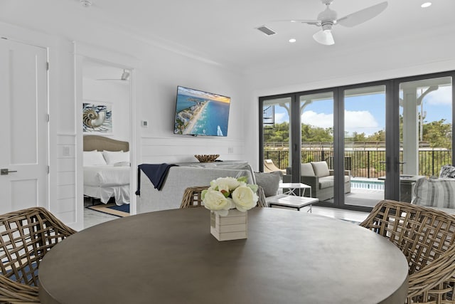 dining area with crown molding, a wealth of natural light, and ceiling fan