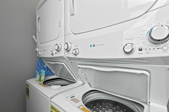 clothes washing area featuring stacked washer and clothes dryer and separate washer and dryer