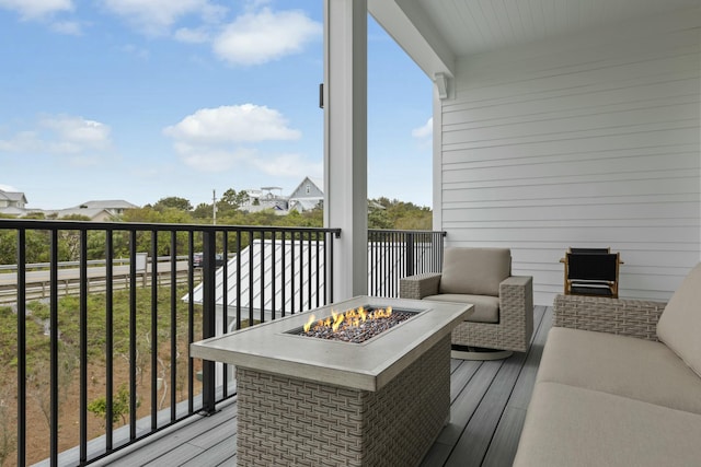 wooden terrace featuring an outdoor fire pit