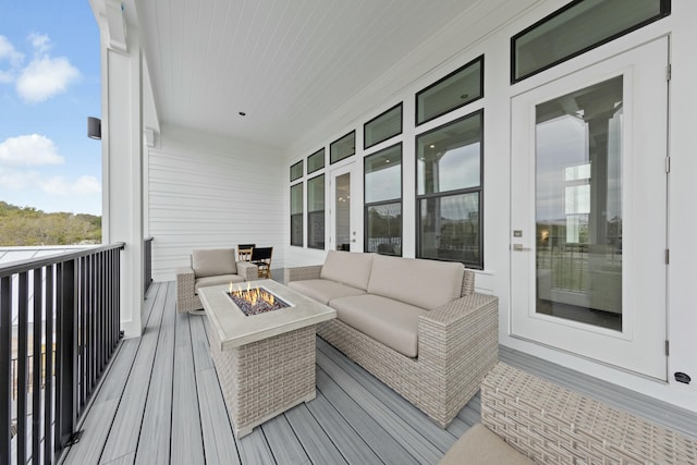 wooden terrace with a fire pit