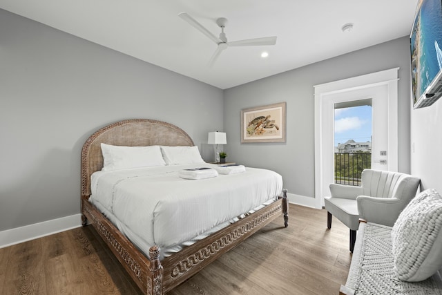 bedroom featuring hardwood / wood-style flooring, access to exterior, and ceiling fan