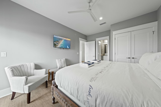 bedroom with ceiling fan, ensuite bathroom, a closet, and light wood-type flooring