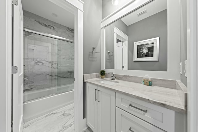 bathroom featuring vanity and combined bath / shower with glass door