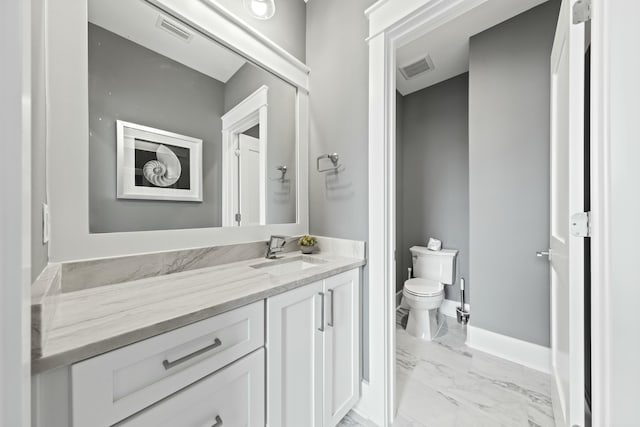 bathroom featuring vanity and toilet