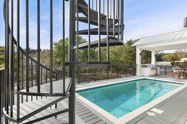 view of pool featuring area for grilling