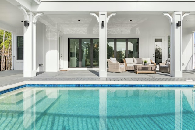 view of swimming pool with an outdoor living space and a patio area