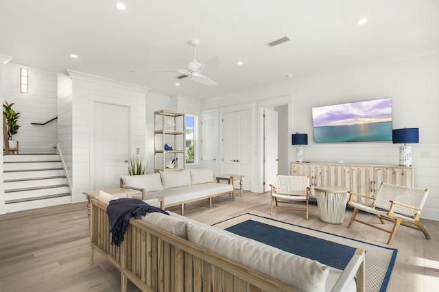 living room with ceiling fan and light wood-type flooring