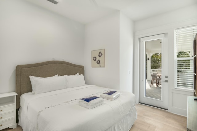 bedroom featuring access to outside and light wood-type flooring