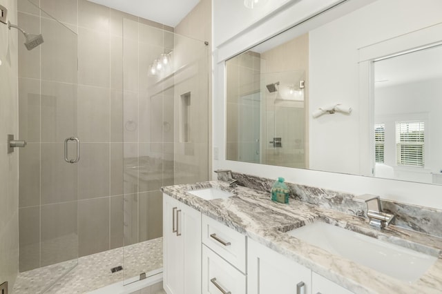 bathroom with vanity and a shower with shower door