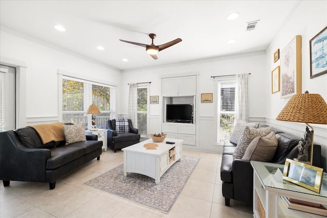 54 Rue Du Soleil, Santa Rosa Beach, FL 32459 - living room featuring healthy amount of natural light, crown molding, a ceiling fan, light tile patterned floors, and a wainscoted wall