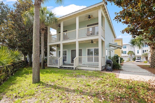 54 Rue Du Soleil, Santa Rosa Beach, FL 32459 - view of front of property with a ceiling fan, a front lawn, a balcony, and a porch