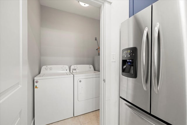 54 Rue Du Soleil, Santa Rosa Beach, FL 32459 - laundry area featuring washing machine and clothes dryer and light tile patterned floors