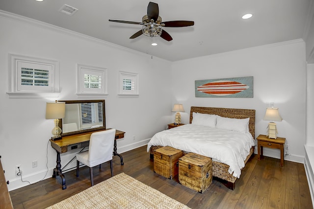 bedroom with ornamental molding, dark wood-type flooring, visible vents, and baseboards