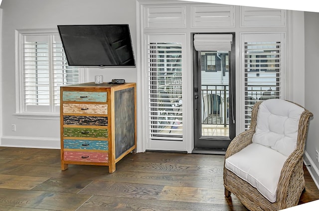 living area featuring dark wood-type flooring and baseboards