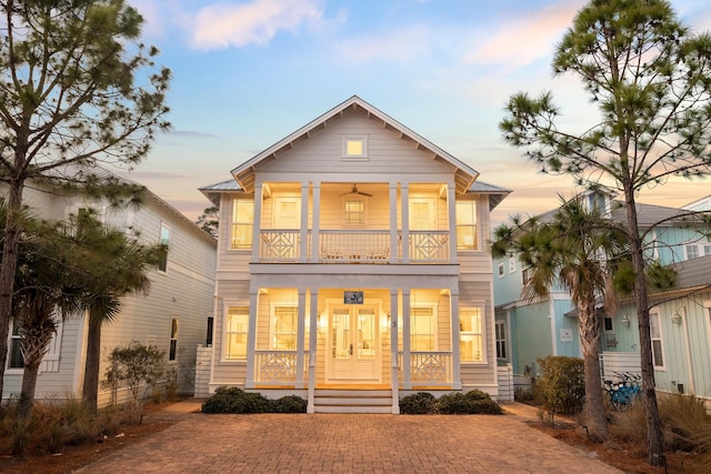 exterior space with covered porch and a balcony