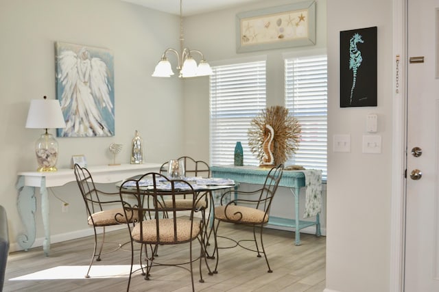 dining room with an inviting chandelier and light wood-type flooring