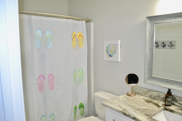 bathroom featuring vanity, a shower with curtain, and toilet