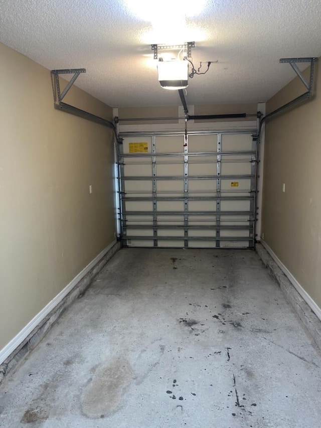 garage with baseboards and a garage door opener