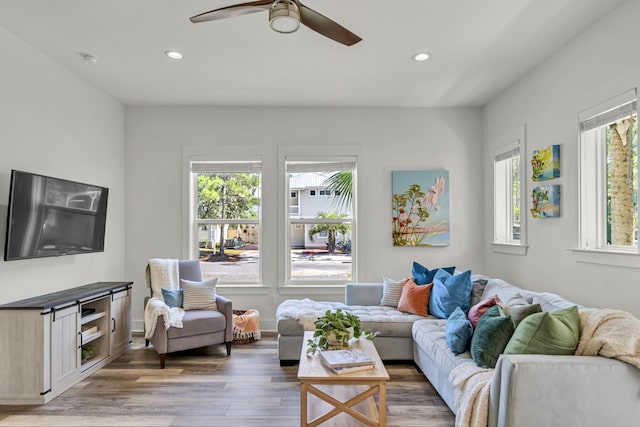 living area with baseboards, wood finished floors, a ceiling fan, and recessed lighting