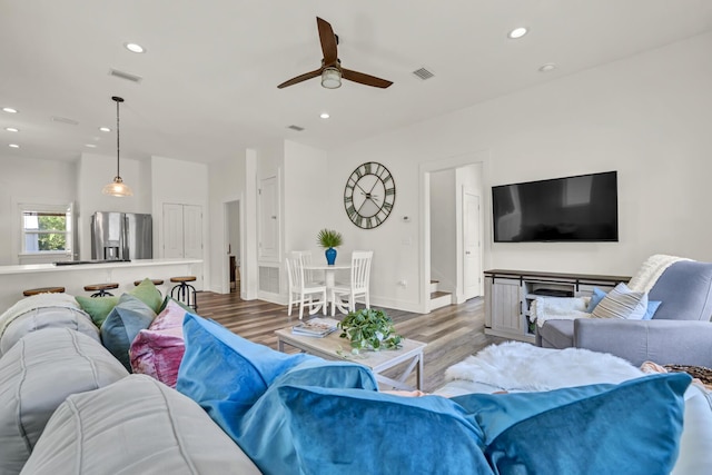 living room featuring wood finished floors, visible vents, and recessed lighting