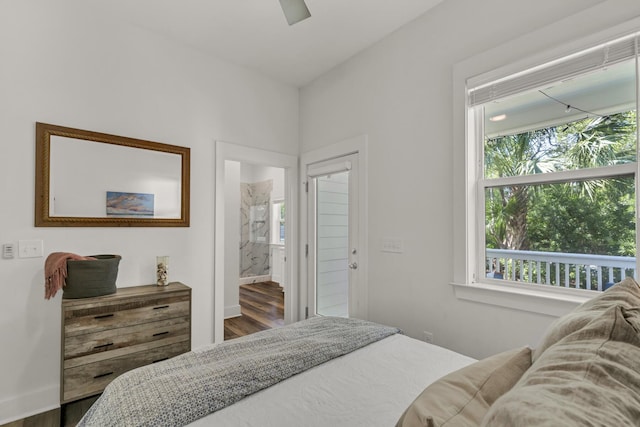 bedroom with ceiling fan, ensuite bath, and wood finished floors