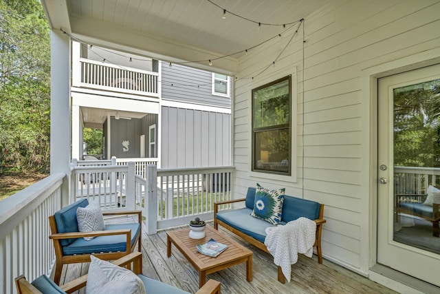 wooden terrace featuring an outdoor living space