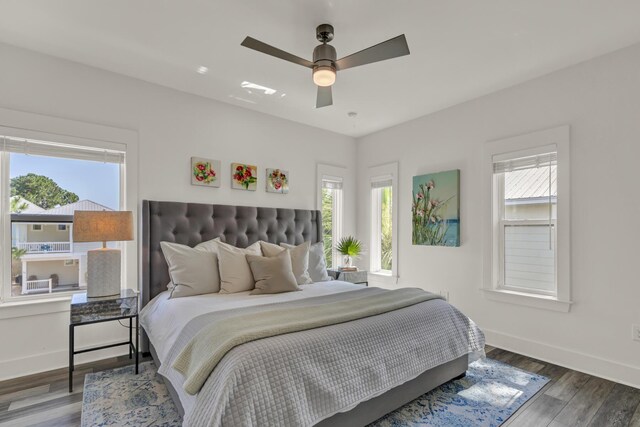 bedroom with ceiling fan, baseboards, and wood finished floors