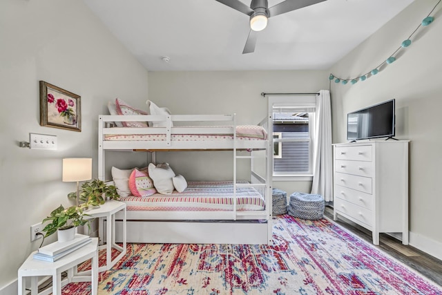 bedroom featuring baseboards, a ceiling fan, and wood finished floors